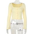 Detailed close-up of pale yellow knit cardigan with square neck and button front - S / Yellow