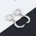 Macro shot of silver crescent moon hoop earrings with a hammered metal texture finish - Moon - Steel