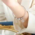 Silver steel cable bracelet featuring numeric eight charms with pavé cubic zirconia - Steel (Z265)