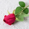 Single red artificial rose with lifelike velvet petals and green leaves on white knit - Rose Bud (Rose Red)