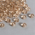 Macro detail of faceted champagne crystal glass beads with hole for DIY jewelry making - Champagne