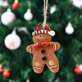 Close-up of a resin gingerbread man ornament with a red hat on a Christmas tree - Red Bow Style