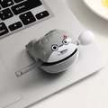 Angry face cartoon cable organizer biting a grey wire on a silver laptop keyboard - Sacabambaspis Wooden Fish - Angry Single