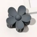 Detailed close-up of a matte dark grey floral claw clip with a resin flower design - Matte Flower Hair Clip - Blue Gray