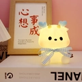 Cartoon deer night light with blue heart antlers and warm yellow glow on a book - Little Dragon/Blue Ribbon