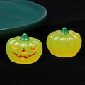 Glow-in-the-dark resin Halloween pumpkins with jack-o'-lantern carving on black velvet - Luminous Yellow Pumpkin Orange Eyes / 3D