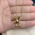 Detailed hand-held view of the gold bear pendant with polished finish and bead chain necklace - Polished Gold Style (J)