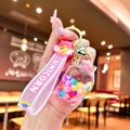 Close-up of pink unicorn keychain with colorful beads in a liquid sand bottle detail - Glow-in-the-dark Rainbow Candy Beans [gas Cylinder]