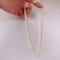 Double-layered necklace featuring white oval freshwater pearls and golden chain with ball pendant - Bead Chain / Gold