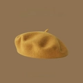 Detail of premium mustard yellow wool beret featuring 2023AW minimalist branding - One Size / Yellow