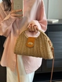 Straw beach bag with brown leather flap and adjustable strap on pink shirt model - Khaki