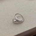 Macro detail of silver drop-shaped ring with polished mirror finish on linen surface - Adjustable Open / Silver Water Drop Wrap Ring
