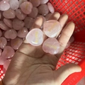 Natural pink crystal heart stone with Healing gold engraving held in hand - Healing