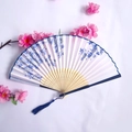 Bamboo folding fan with blue floral silk print, blue tassel, and cherry blossom decor - White and Blue Floral Style (Smile Women's Fan-28)