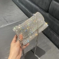 Mini silver rhinestone evening bag with chain strap shown in a hand-held display - Style 1 Silver