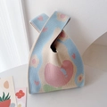 Detailed knit tote bag texture showing heart pattern and colorful patchwork fabric - Blue Tulip