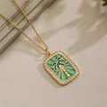 Macro shot of gold palm tree tarot pendant with colorful enamel and crystal pavé details - Palm Tree