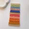 Detailed set of multi-colored textured elastic hair ties on brown cardboard cards - Bamboo Texture Brick Red Set / 32 Pieces