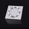 Detailed view of turquoise stone beaded bracelet on metallic stand with marble patterns - Multi Stone Combination