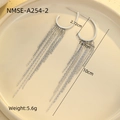 Detailed view of silver stainless steel tassel earrings with zircon on a beige tray - Silver Hoop Chain Tassel