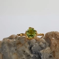 Golden S925 sterling silver ring with square olive green gemstone on a natural rock - Peridot Square Organic Style (LR238)