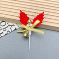 Detail of Christmas cake topper with holly leaves, red bow, and golden bell ornaments - Leaves-2002