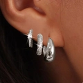 Detailed view of silver-tone hoop earring set with cubic zirconia worn on ear lobe - Three-Piece Set / Silver