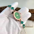 Detail of rose gold oval quartz watch with green dial and leaf-shaped gemstone links - Green Oval