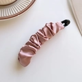 Elegant pink pleated satin banana hair clip for high ponytail fixation on white desk - Pink