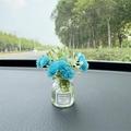 Mini glass vase car ornament with blue faux flowers and Good Luck label on dashboard - Blue Baby's Breath