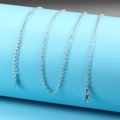 Macro shot of silver stainless steel chain with lobster clasp and adjustable extension link - 40+5cm / Steel