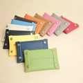 Macro detail of various colors in lychee grain leather mini pouches with metal snap buttons - Pink