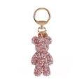 Detailed close-up of pink diamond-studded bear keychain with rose gold lobster clasp - Holographic Pink