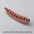 Detail of matte terracotta banana hair clip with multi-tooth grip and large 13cm sizing - Large / Pink