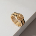 Vintage gold lion head ring with black enamel details on a textured stone surface - Gold Lion Head