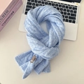Detailed view of light blue cable knit wool scarf with premium leather brand tag - Light Blue