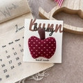 Detailed view of a handmade burgundy checkered fabric apple hair clip on a card - Polka Dot Apple Hair Clip