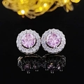 Macro detail of pink zircon halo stud earrings with silver setting on reflective surface - Round Pink Style (E232)