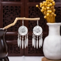 Ethnic silver-plated dangle earrings featuring round carved disks and feather tassels - Silver Round Feather Tassel(E1092-1)