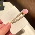Dettaglio del fermaglio per capelli con perle e conchiglia rosa glitterata su base oro - 1# Conchiglia a Goccia - Rosa