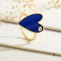Detail of adjustable gold ring featuring a large blue heart enamel and small inlaid gemstone - Heart / Blue (RG0664-I)