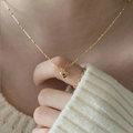 Golden heart pendant necklace with fine satellite chain on white knit background - Ultra-thin Gold Heart Necklace