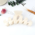 Elegant cream-colored matte wavy shark hair claw clip for bun hairstyles in a trendy design - Ivory
