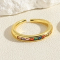 Close-up of adjustable gold ring featuring vibrant rainbow baguette cut cubic zirconia - Square Colorful Zirconia