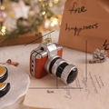 Miniature camera Christmas ornament in silver and orange with a festive gold string - Camera