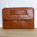 Detailed view of the brown PU leather messenger bag with top handle and fine stitching - Brown