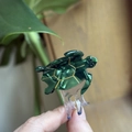 Close-up of small acetate turtle hair claw clip with gold accents and tortoiseshell finish - Emerald Green - Small (Approx. 4.5cm)