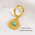 Detailed macro view of gold hoop earring with turquoise stone sunburst charm - Amazonite