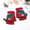Detailed view of red knitted children's gloves with flip top and cartoon dinosaur motif - Red