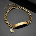Macro detail of gold Cuban chain bracelet featuring custom engravable bar and butterfly charm - Butterfly Pendant Bracelet-Gold